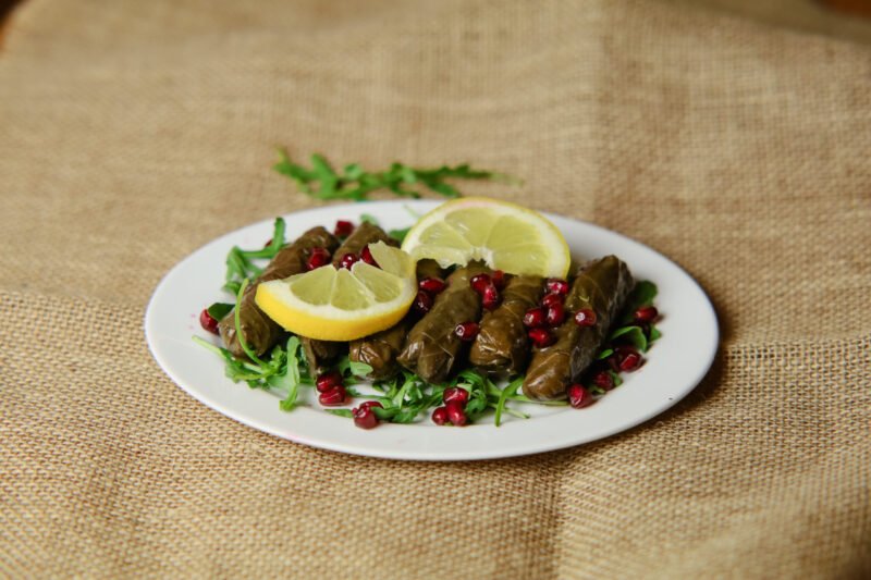 yalangi image yalangi is a Grape leaves filled with rice, tomato, parsley, pomegranate, lemon juice, and pomegranate sauce.