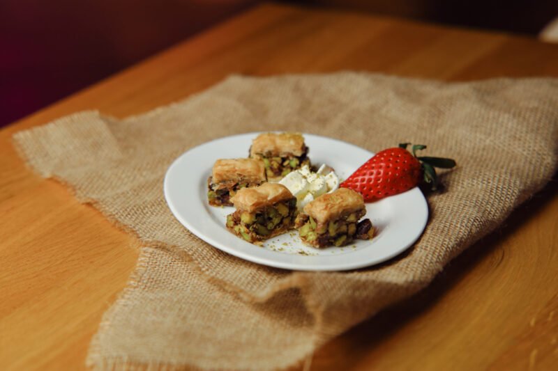 baklava Layers of puff pastry with honey and pistachios (4 pieces).