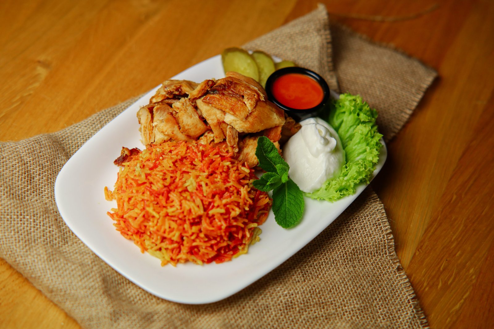 chicken with rice meal Served with chicken shawarma, smoked rice, salad, and garlic sauce.