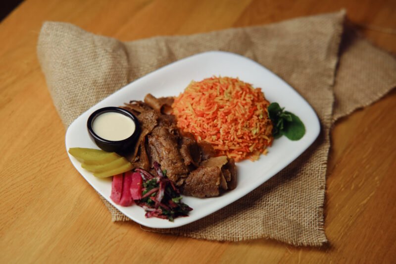 beef with rice meal Served with beef shawarma, smoked rice, salad, and tahini sauce.