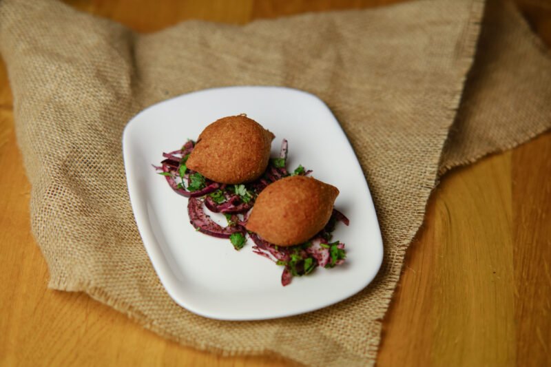kibbeh image Traditional Lebanese kibbeh filled with minced meat, walnuts, onion, and spices. (2 pieces)