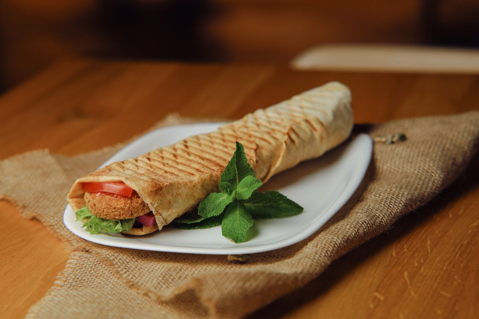 falafel image hummus, falafel, cucumber, pomegranate, kohlrabi, tomato, parsley, salad, lemon and tahini sauce.